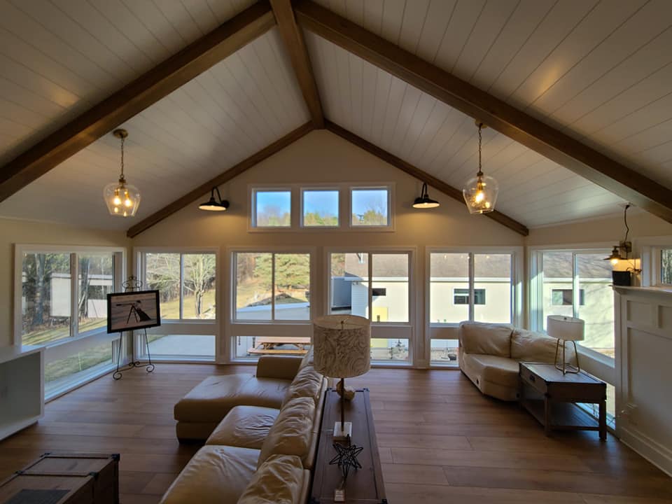 Great room with a wall of windows and pendant lighting, alternate angle